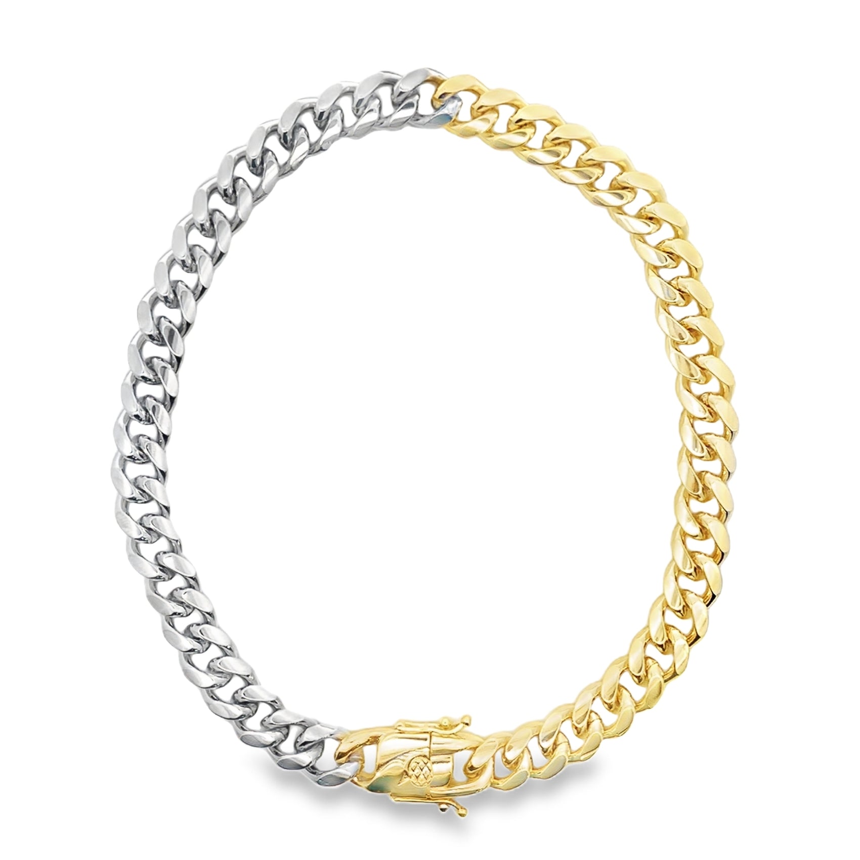 A two-tone cuban link chain bracelet showcases alternating sections of polished silver and yellow gold with a secure clasp.