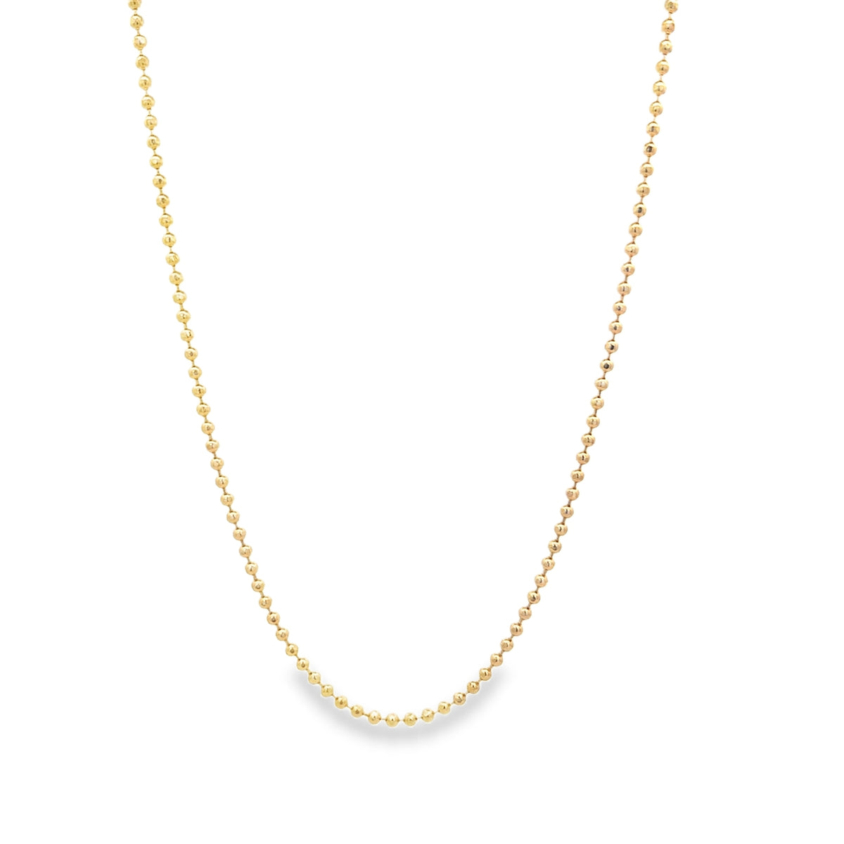 A delicate yellow gold ball chain necklace hangs in a graceful curve against a plain white background.