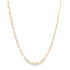 A delicate tricolor gold Figaro link chain necklace drapes against a clean white background.