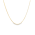 A delicate gold chain necklace drapes in a graceful curve against a clean white background.