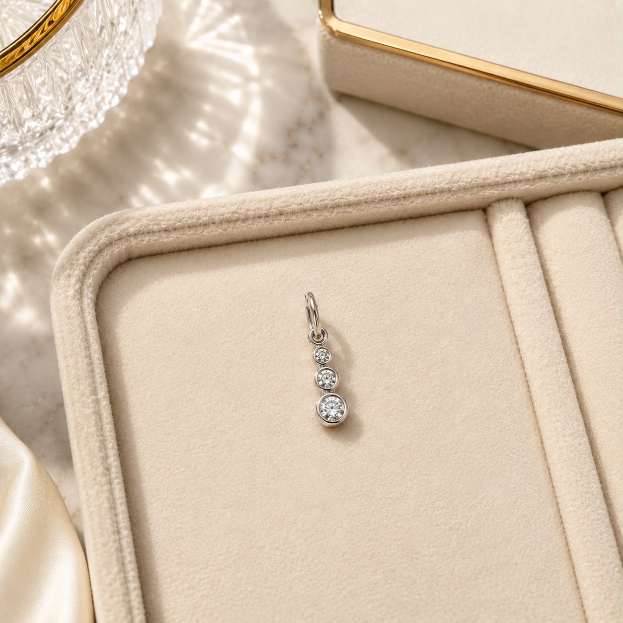 Add timeless sparkle with this Triple Bezel CZ Drop Charm crafted in durable 18K Gold Filled. Features three graduated bezel-set cubic zirconia stones for a delicate, elegant look.