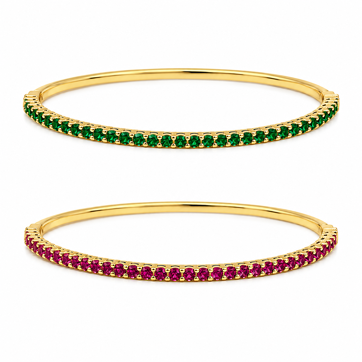 Two elegant gold bangles rest against a clean white background, one shimmering with vibrant green emeralds and the other glowing with deep red rubies.