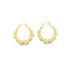 A pair of textured gold bamboo hoop earrings rests against a clean white background.