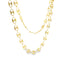 A double-layered gold puff mariner link chain necklace drapes gracefully against a white background.