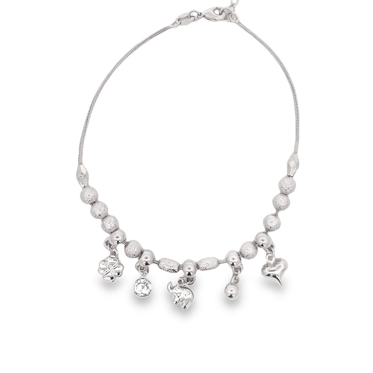A delicate silver charm bracelet displays dangling charms, including a flower, a crystal, an elephant, and a heart, against a clean white background.