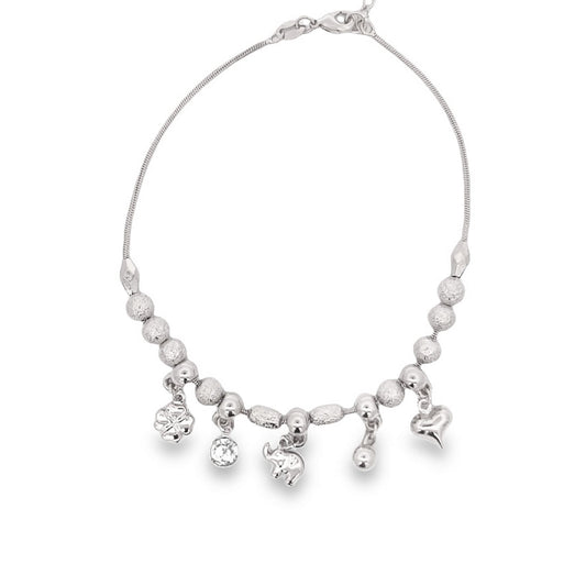 A delicate silver charm bracelet hangs gracefully, displaying assorted dangling charms including a clover, an elephant, and a heart against a plain white background.
