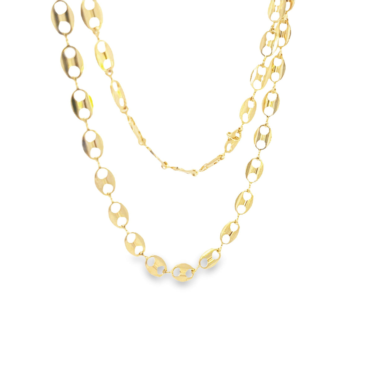 A delicate gold chain necklace with distinct oval links rests against a clean white background.