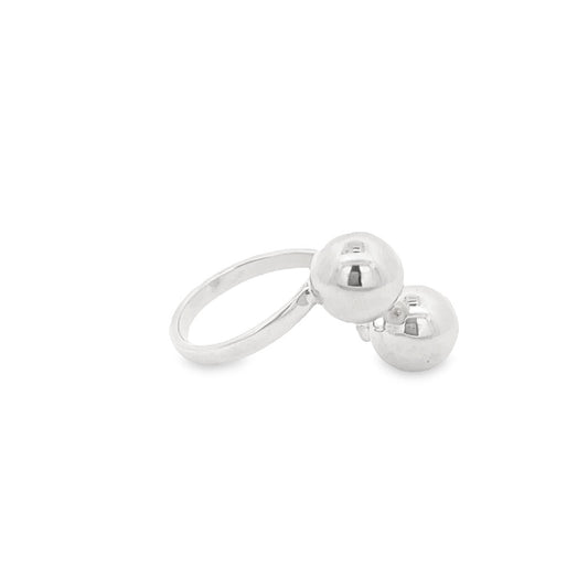 A shiny silver statement ring features two polished spherical balls resting side by side on a clean white background.