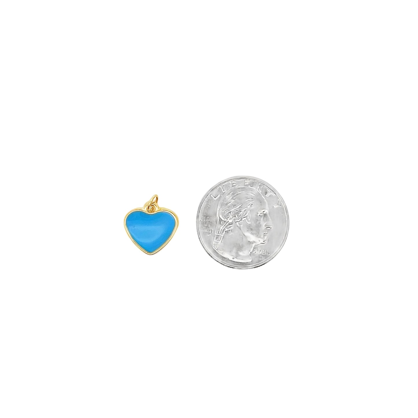 A small blue enamel heart charm in gold sits next to a US quarter coin for scale.