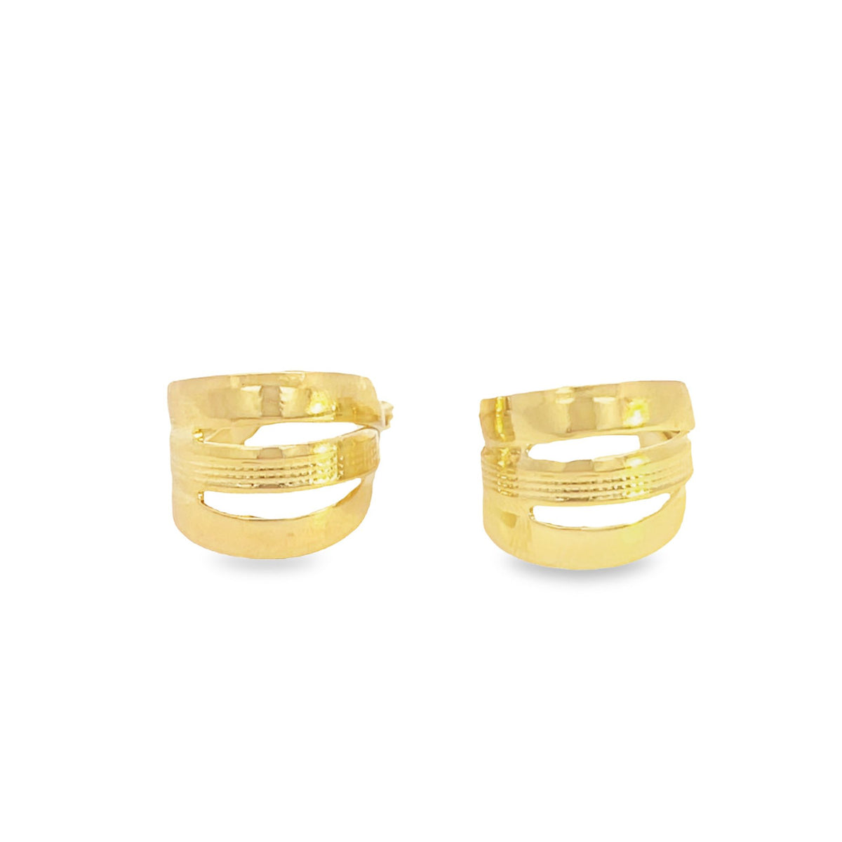 A pair of sleek gold earrings featuring a wide, multi-band geometric design shine against a clean white background.