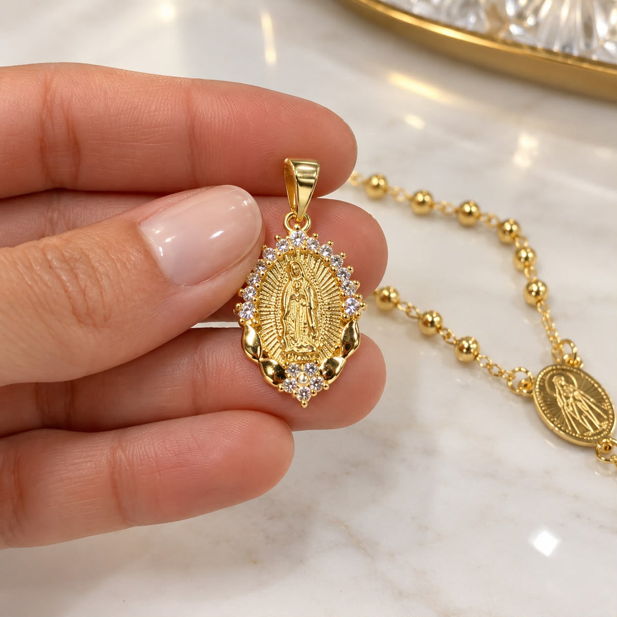 Shop the Virgin of Guadalupe pendant in 18K Gold Filled, detailed with a radiant halo of clear CZ stones. A meaningful piece of religious jewelry.