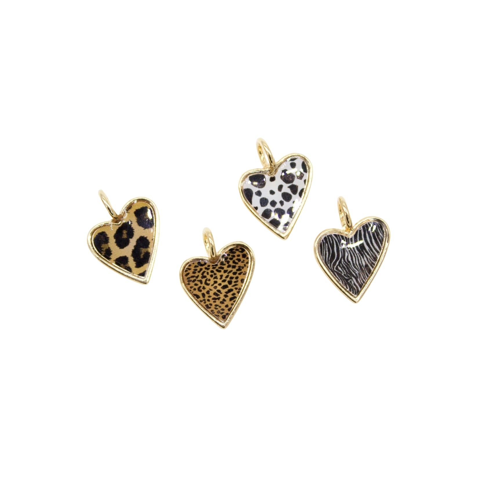 Four gold-rimmed heart charms display various animal print patterns against a white background.