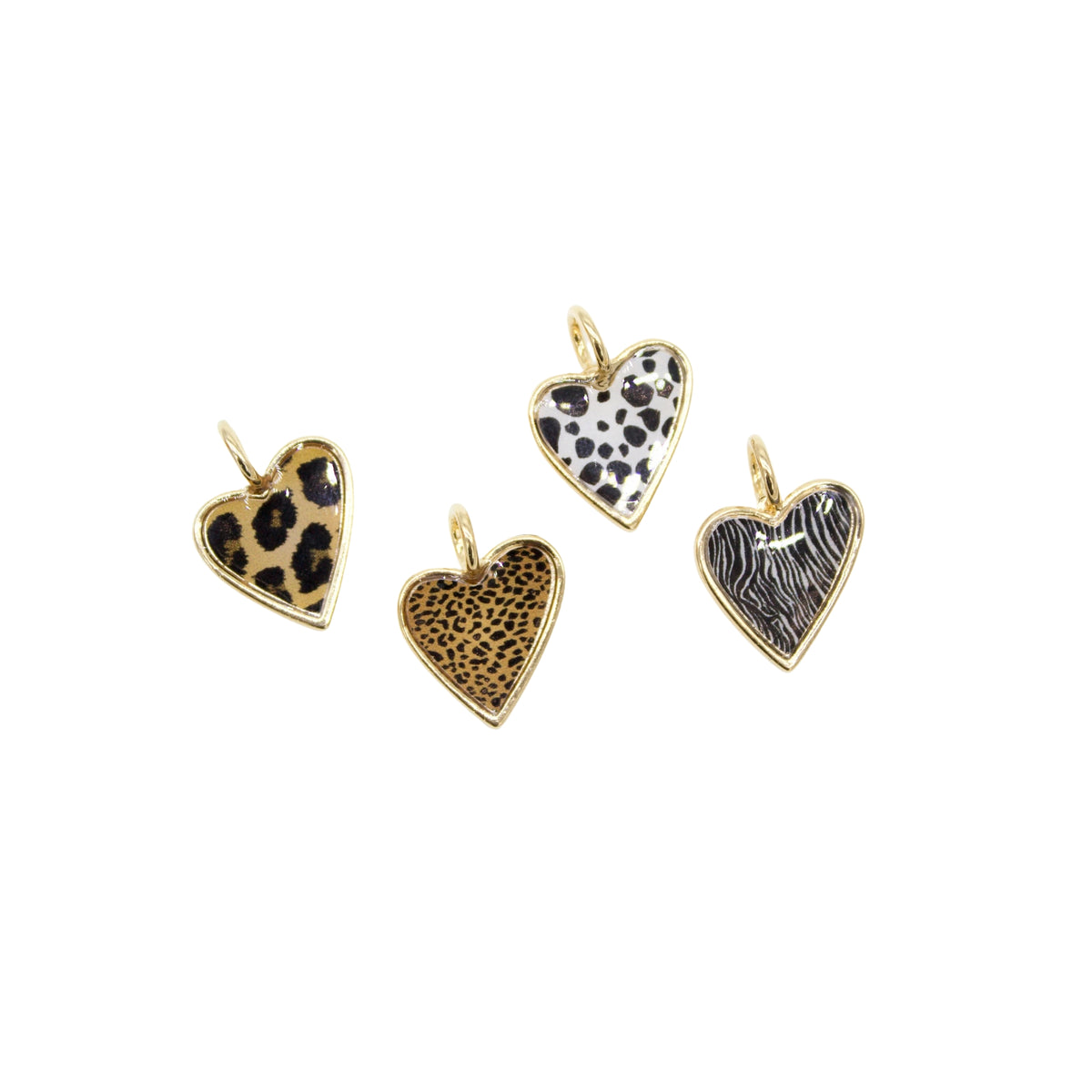Four gold-rimmed heart charms display various animal print patterns against a white background.
