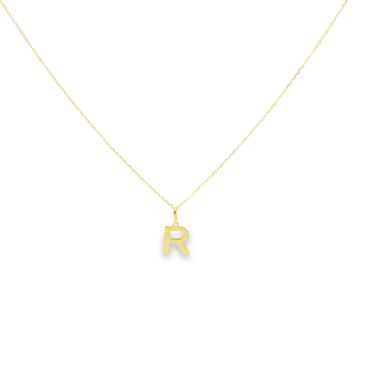 A delicate gold chain necklace displays a shiny initial R pendant.