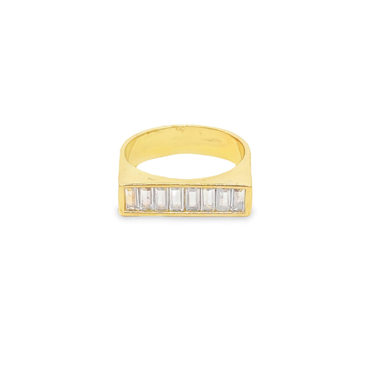 A gold ring features a rectangular face set with a row of clear baguette-cut diamonds against a white background.