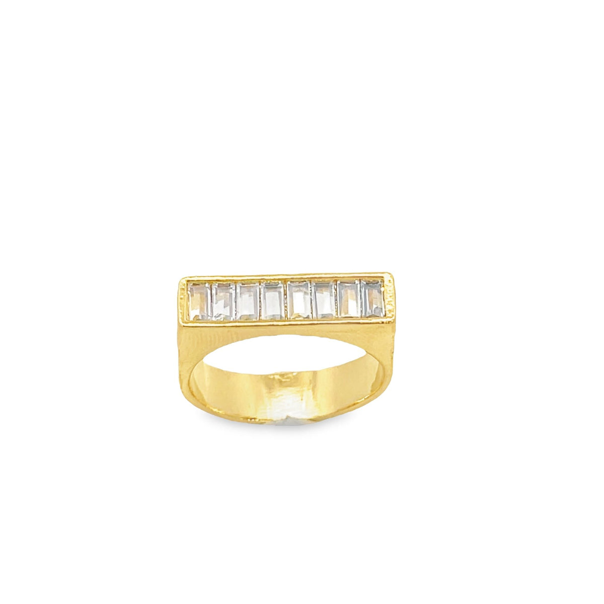 A gold ring features a rectangular face set with a row of clear baguette-cut diamonds against a white background.