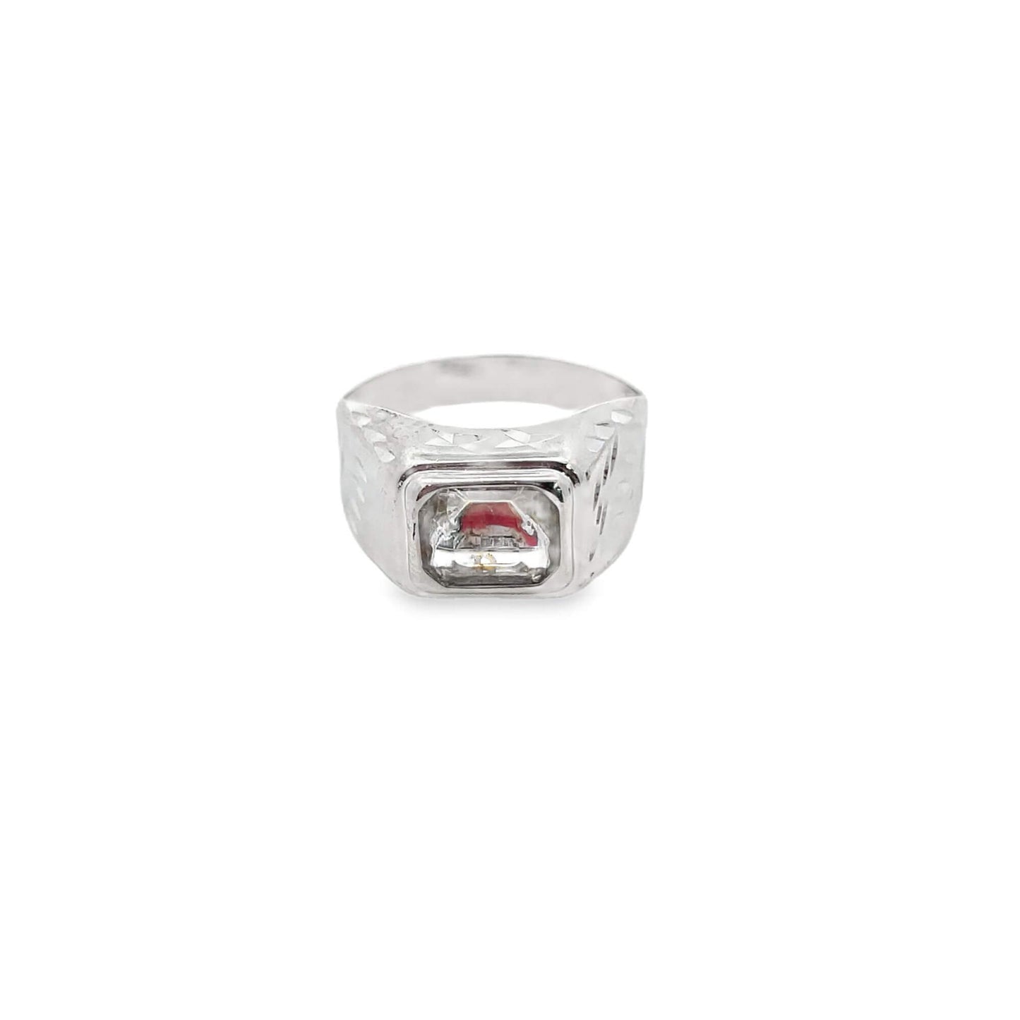A silver men's signet ring features a rectangular clear stone with a red accent nestled inside its textured setting.