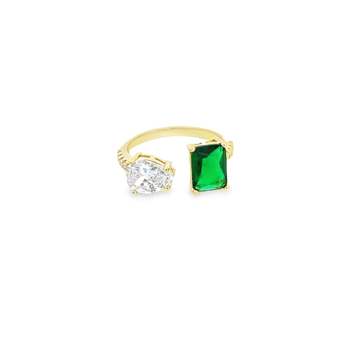 A gold open-shank ring features a pear-shaped diamond alongside a vibrant emerald-cut green gemstone.