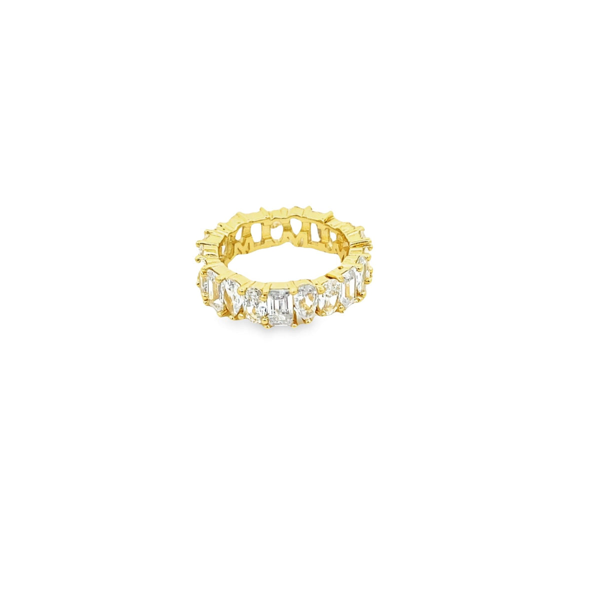A gold eternity band features a continuous row of sparkling emerald-cut and round diamonds against a clean white background.