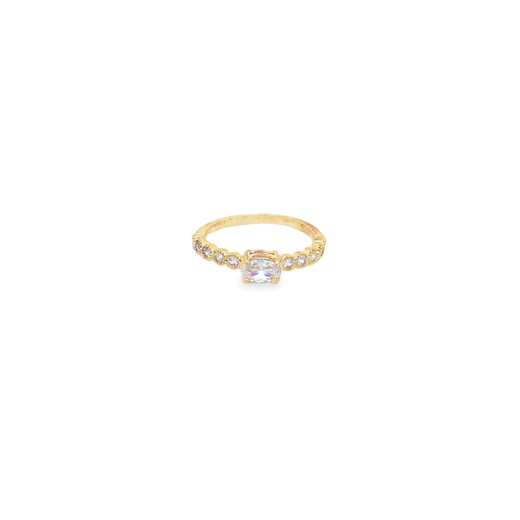 A delicate gold ring showcases a sparkling cushion-cut diamond center stone accented by smaller round diamonds along the band.