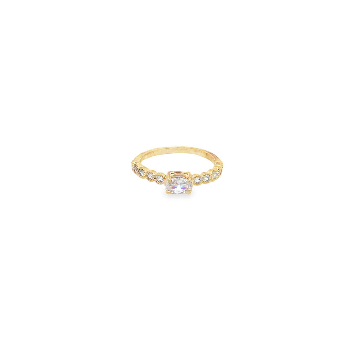 A delicate gold ring showcases a sparkling cushion-cut diamond center stone accented by smaller round diamonds along the band.