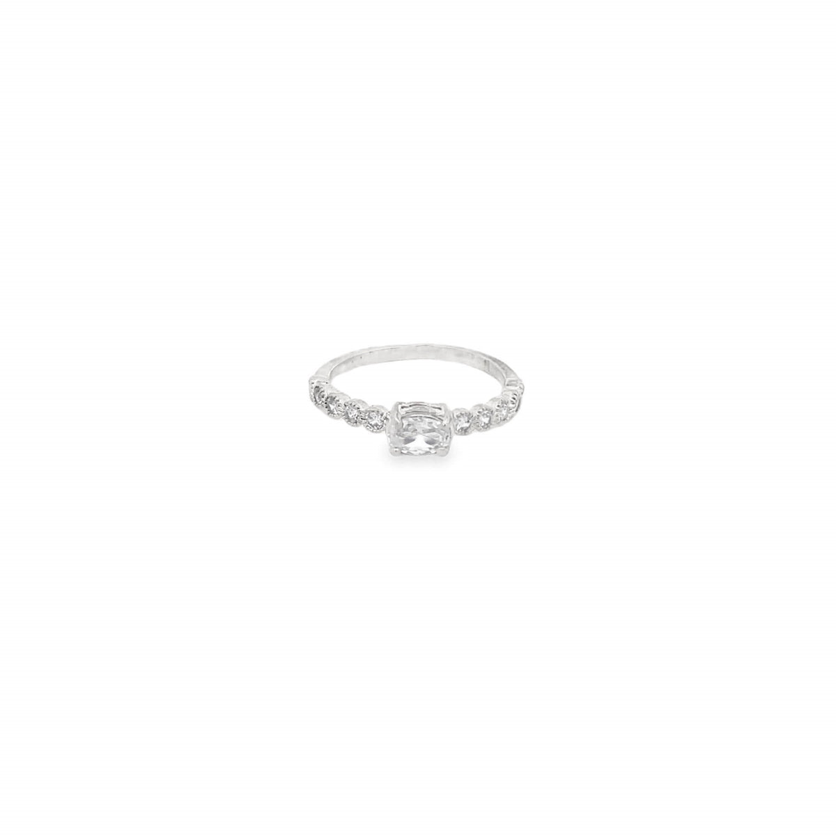 A delicate silver ring features a central cushion-cut gemstone accented by sparkling pavé diamonds along the band against a clean white background.