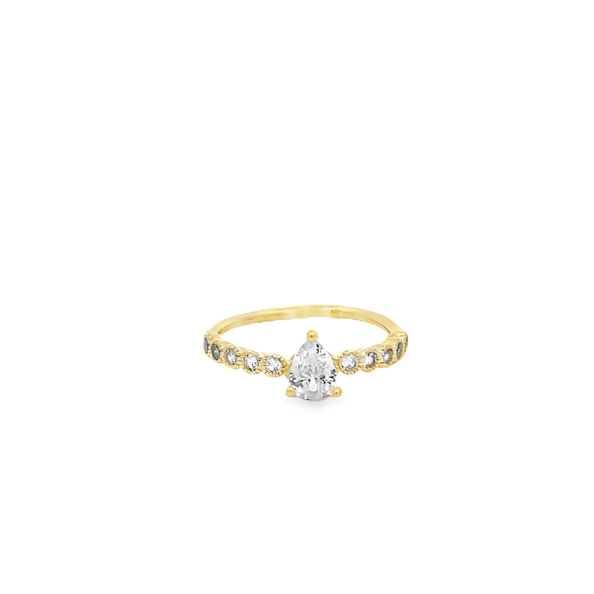 A delicate gold ring features a central pear-cut diamond flanked by sparkling accent stones along the band.