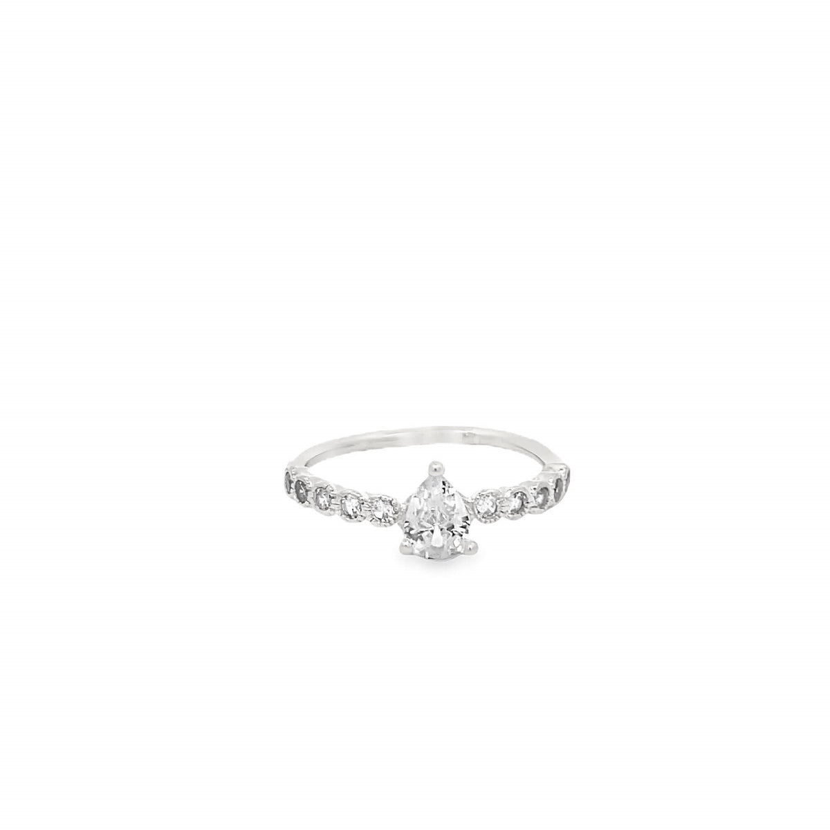 A delicate silver ring features a prominent pear-cut diamond center stone flanked by smaller sparkling round diamonds along the band.