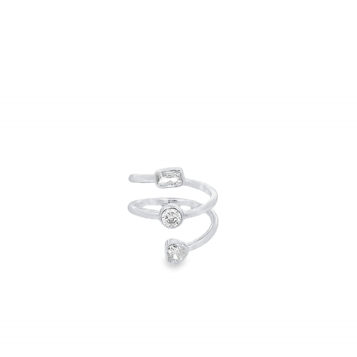 A modern silver wrap ring features three distinct stone shapes including a baguette, round bezel, and heart-cut diamond.