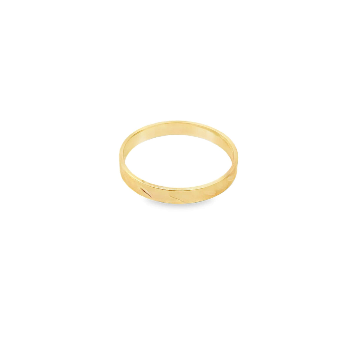 A sleek yellow gold band ring rests against a plain white background.