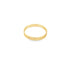 A sleek yellow gold band ring rests against a plain white background.
