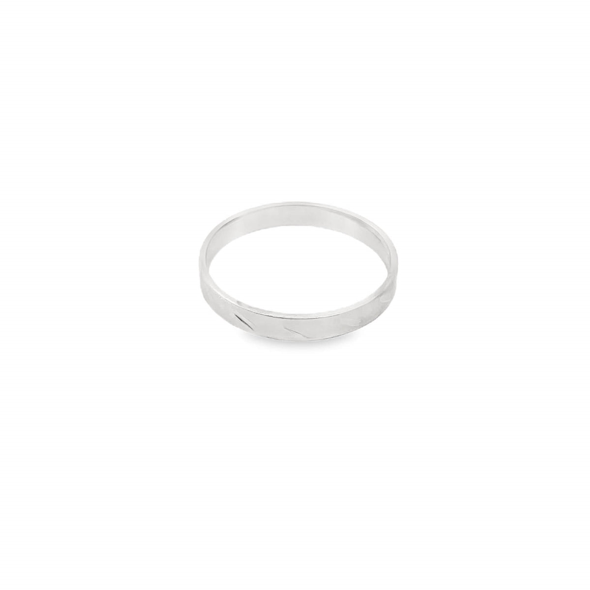 A sleek silver band ring rests against a clean white background, showcasing its subtle engraved pattern.