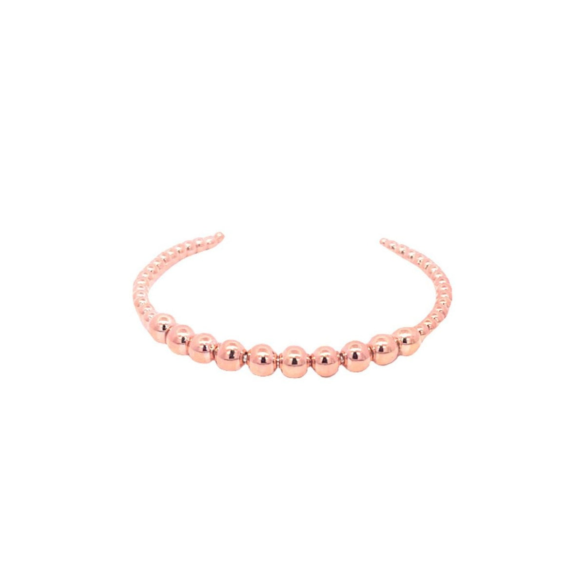 A polished rose gold beaded cuff bracelet rests against a clean white background.