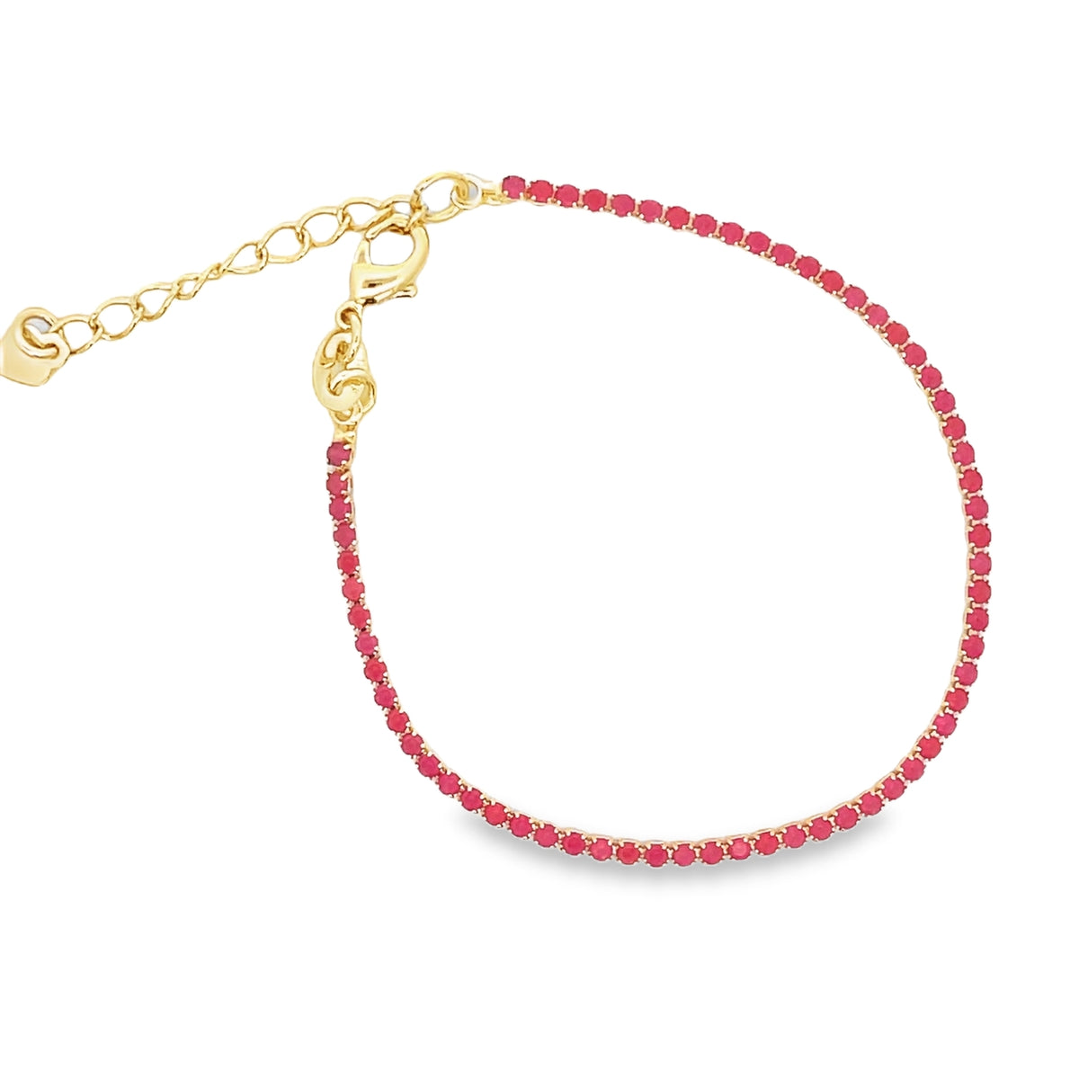 A delicate gold tennis bracelet features a continuous line of vibrant pink gemstones and an adjustable chain clasp.