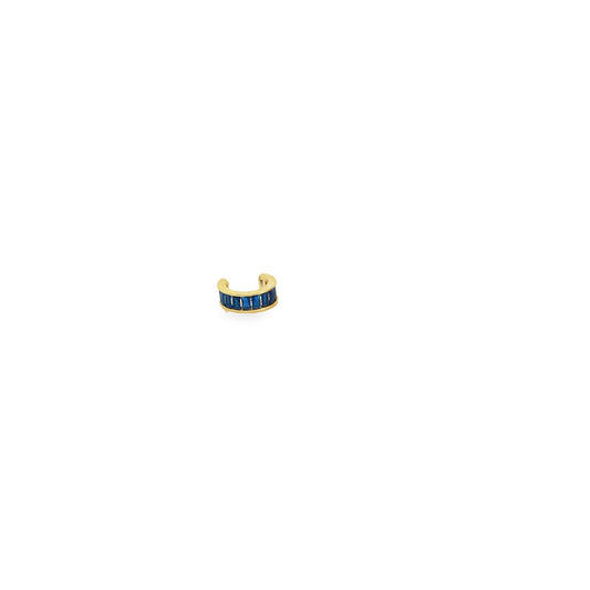 A gold ear cuff features a row of vibrant blue baguette-cut stones against a clean white background.