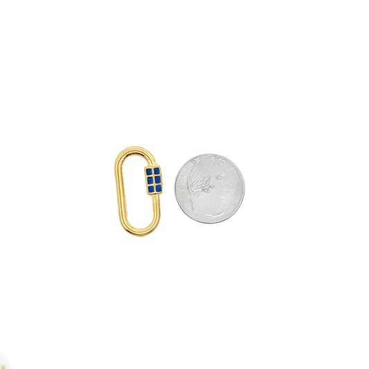 A gold oval charm clasp accented with four blue square enamel insets sits next to a US dime for size comparison.