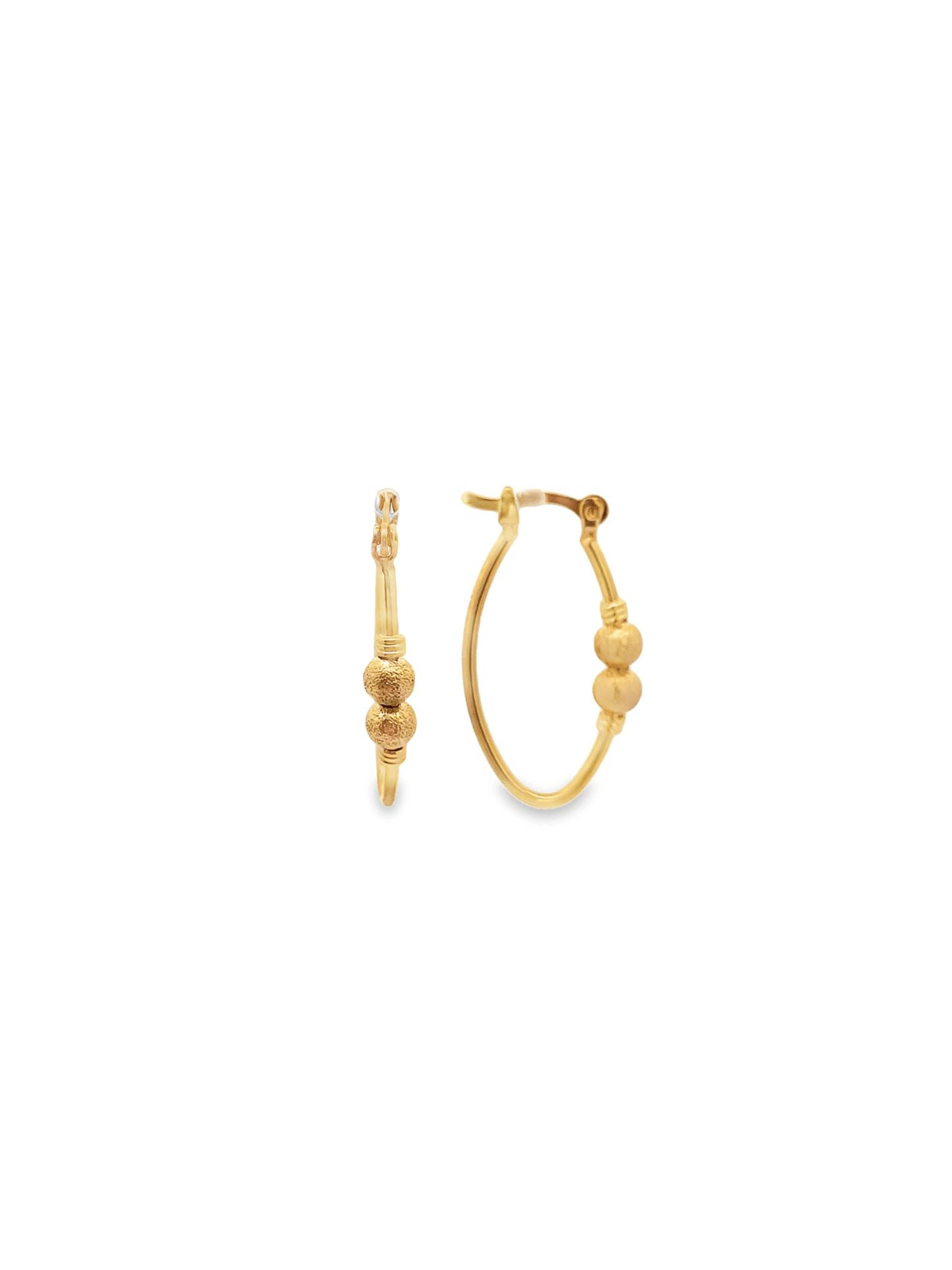 A pair of gold hoop earrings features two textured bead charms centered along the bottom curve.