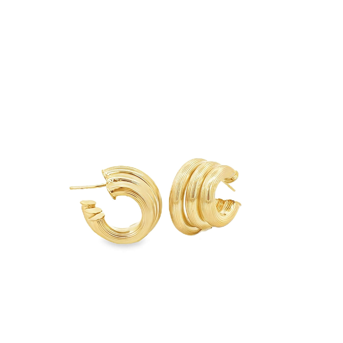 A pair of textured gold hoop earrings rests against a clean white background.