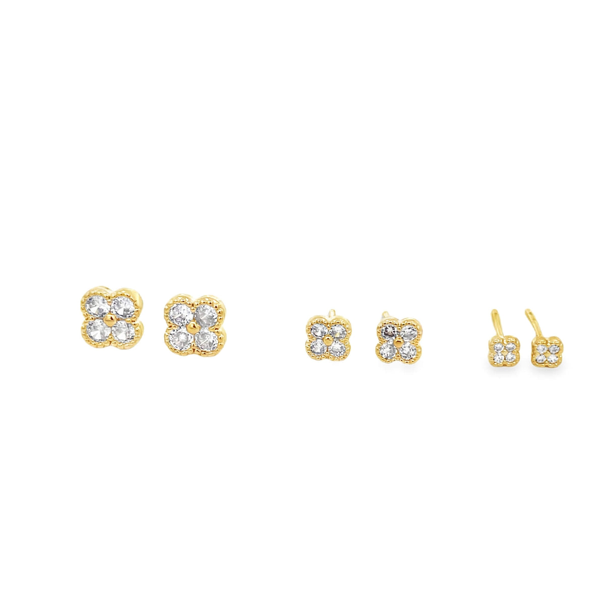 Three pairs of gold clover stud earrings sparkle with delicate pave diamonds on a clean white background.