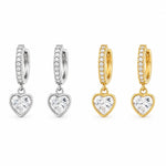 Elegant 18K Gold Filled pave huggie earrings featuring sparkling heart-cut CZ drop charms. Lightweight, hypoallergenic, tarnish resistant, and perfect for everyday wear or gifting.
