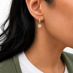 Elegant 18K Gold Filled pave huggie earrings featuring sparkling heart-cut CZ drop charms. Lightweight, hypoallergenic, tarnish resistant, and perfect for everyday wear or gifting.