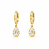 Shop pear-cut CZ drop huggie earrings featuring sparkling pavé hoops and teardrop cubic zirconia stones. 18K Gold Filled in Gold and Rhodium.