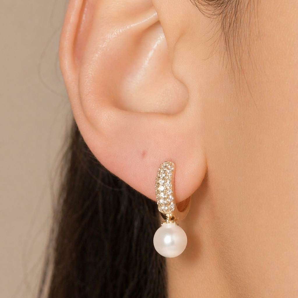 Elegant pearl drop huggie earrings with pavé CZ stones. Minimalist gold hoop earrings perfect for everyday wear or special occasions