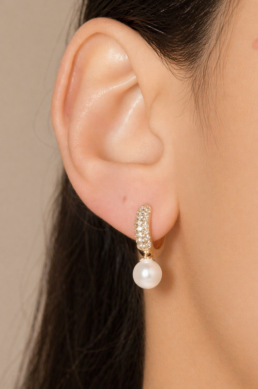 Elegant pearl drop huggie earrings with pavé CZ stones. Minimalist gold hoop earrings perfect for everyday wear or special occasions