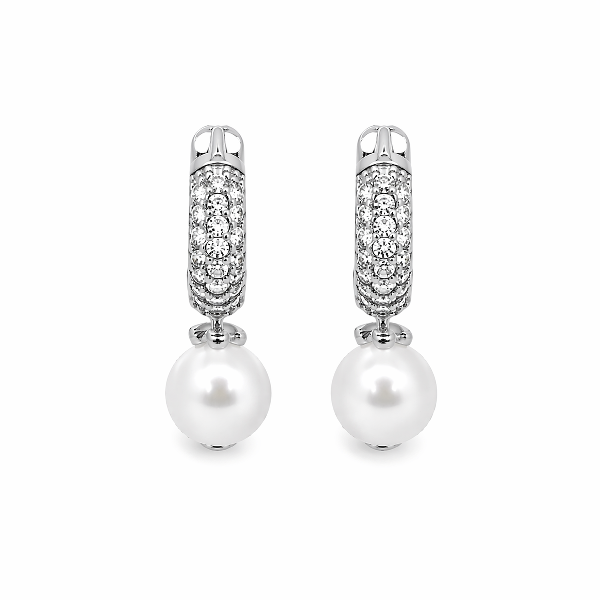 A pair of elegant silver hoop earrings sparkling with pavé-set diamonds dangles suspended white pearls against a clean white background.