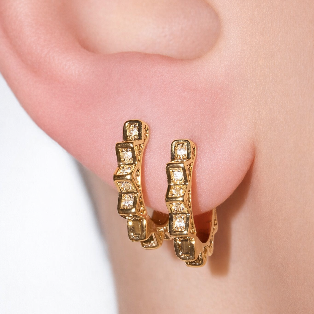 Stylish sunburst huggie hoop earrings with CZ stones. Geometric mini hoops available in gold or silver. Perfect for stacking or everyday wear.