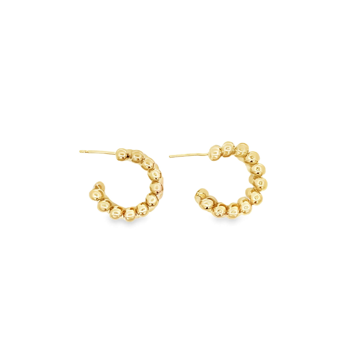 A pair of polished gold beaded hoop earrings resting against a clean white background.