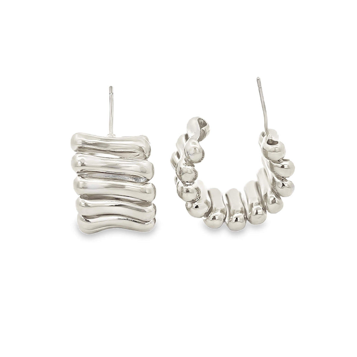 A pair of chunky silver hoop earrings featuring a unique ribbed, bone-like design on a plain white background.