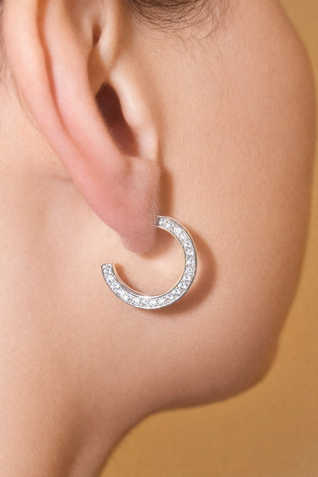Modern pavé open hoop earrings with CZ stones. Minimalist half hoop design Perfect for everyday wear or layering.