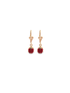 A pair of gold ladybug earrings feature vibrant red enamel with black spots dangling against a white background.